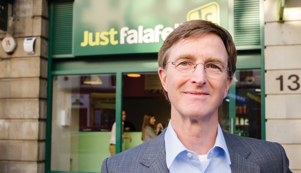  /></p>
<p></p>
<p>But it wasn’t just this diversity that started to pull in the punters. “One of the hallmarks that he had from the beginning was ‘fresh, healthy, natural and vegetarian’,” comments Biggins. Before long, Just Falafel’s approach was beginning to bring in more than just customers – Bitar started to get approached by individuals wanting to buy a franchise. “People know this food, they’ve grown up with it, they saw the wisdom of what Mohamad was doing and they wanted to be a part of it.”</p>
<p></p>
<p>The franchise has always been heavily involved in the use of social media to spread the brand and currently Just Falafel has over 1.5 million likes on Facebook. “It’s been an important vehicle,” says Biggins. “Through the amount of exposure you get through social media, it started getting inquiries literally from all over the world.” Before long, Just Falafel was in negotiations with UK-based restauranteur Ahmad Hariri, who subsequently bought the rights to open 200 outlets. The first Western store opened in Covent Garden in January 2013, bringing the franchise’s unique approach to falafel to our fair shores.</p>
<p></p>
<p>It’s safe to say the UK’s relationship with Just Falafel’s food has been unique. Whilst just 10% of Brits would describe themselves as vegetarian, Biggins points out that we’ve become far more open to meals without meat. “We also find that here in London, people are a little bit bored with the same old same,” he remarks. “You want to have something new, you want to try something different.”</p>
<p></p>
<p>And Just Falafel’s approach to the snack is certainly that. Asian cuisine and chickpea patties may not sound like the most obvious combination but the menu doesn’t shy away from using bold combinations of ingredients, as with its Japanese wrap. “It’s got pickled ginger in there,” Biggins explains. “It’s got avocado in there and it has a wasabi mayonnaise.”</p>
<p></p>
<p><img decoding=