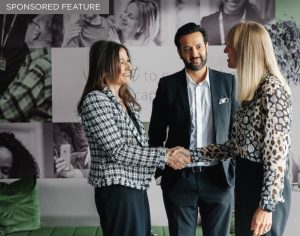 Home Instead franchise network representatives connecting with prospective franchise owners at a franchise exhibition.